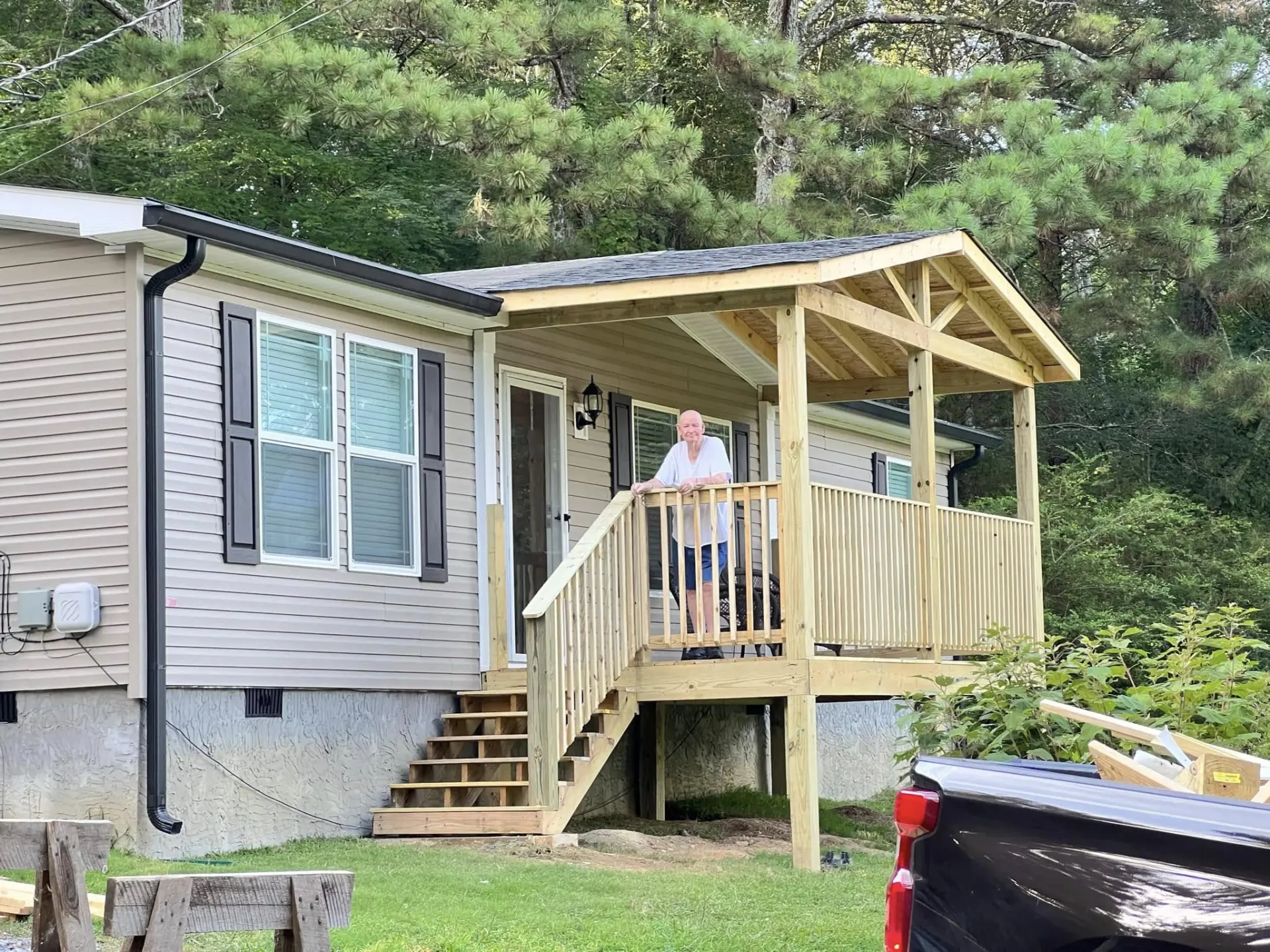 Finished covered porch with gabled roof, railings and stairs