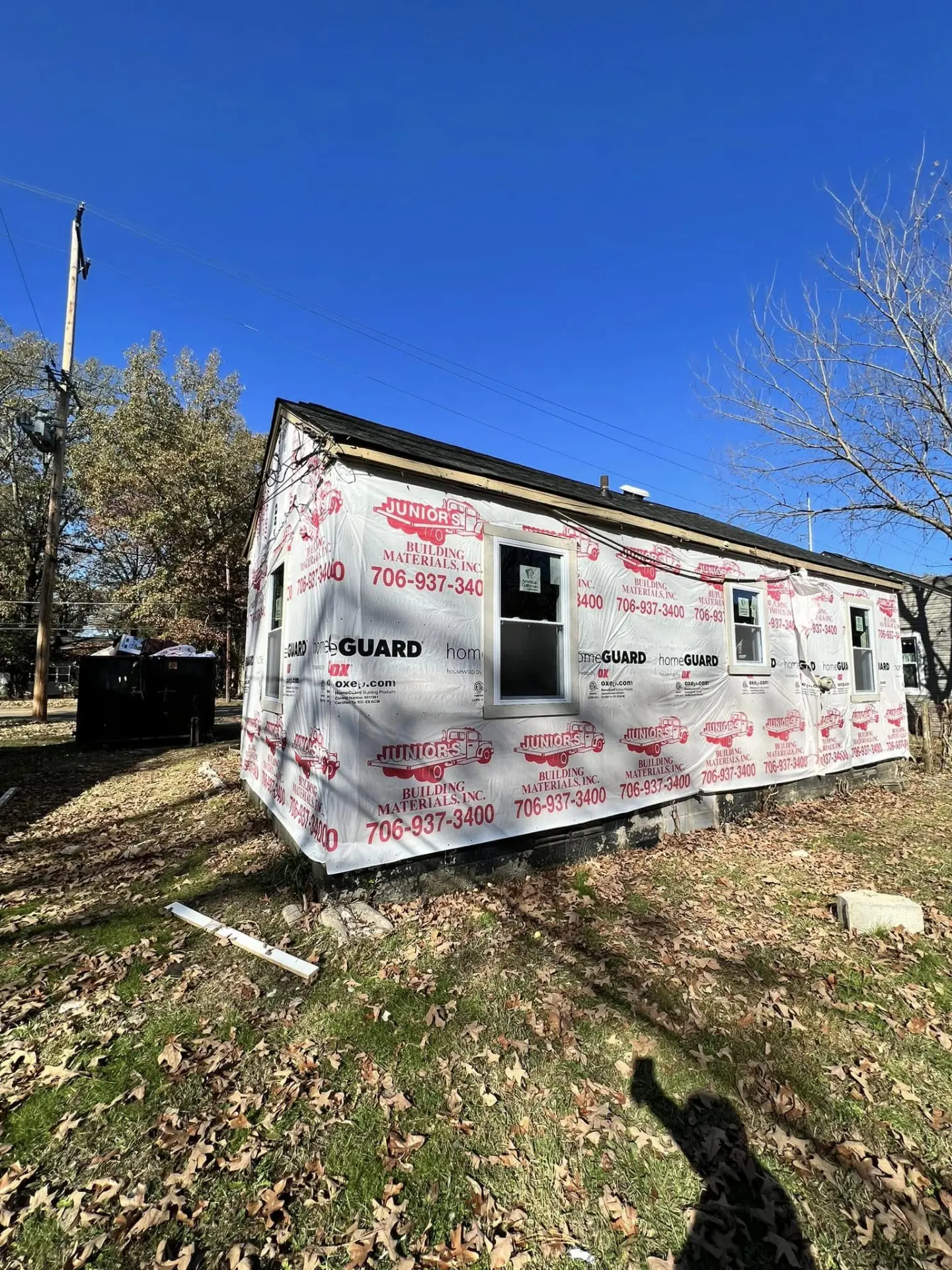 House exterior wrapped in weather barrier during siding or renovation prep