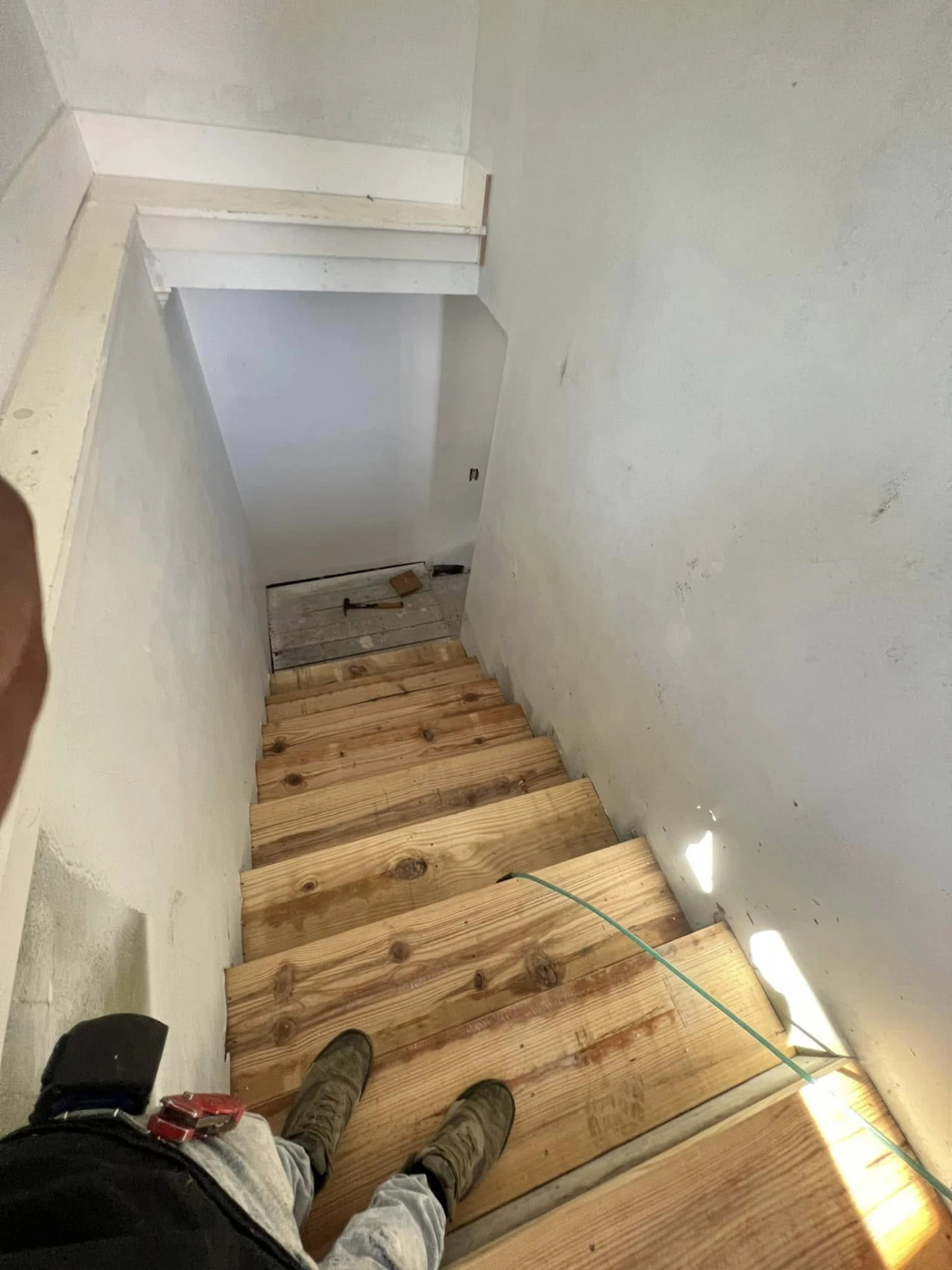 Bare wood stair treads during a stairway rebuild