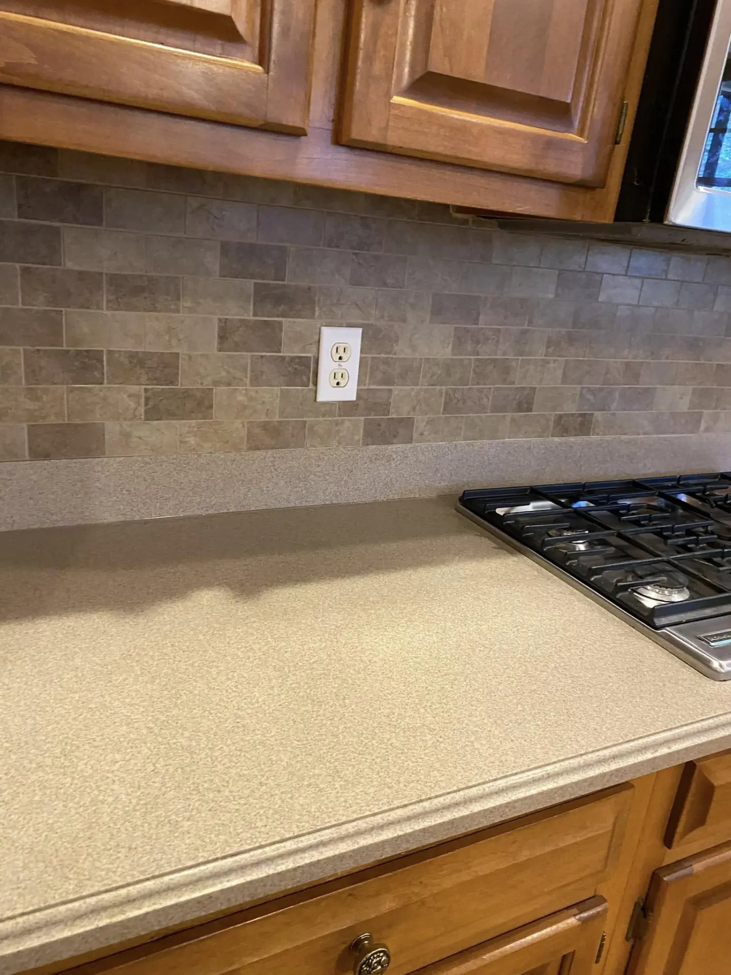 Close-up of a stone subway tile kitchen backsplash
