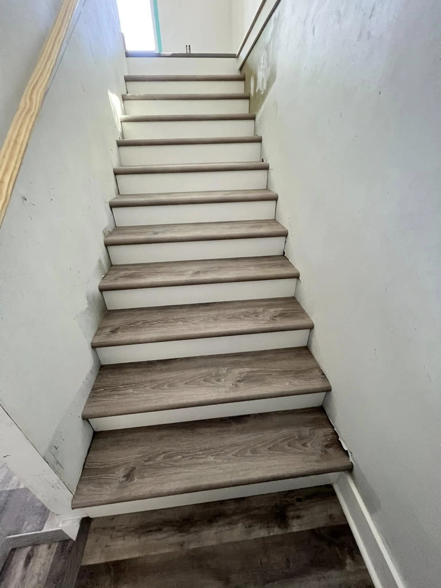Staircase finished with wood-look treads and white risers